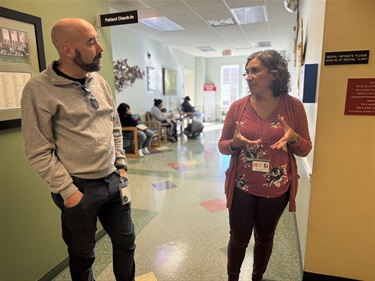 Executive Director Dr. Mercedes leads City Manager Dan Hoffman on a tour of the clinic. City and clinic staff work together to inform residents of the clinic’s services.